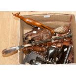 A collection of fifteen hardwood African ornaments, including cutlery utensils,