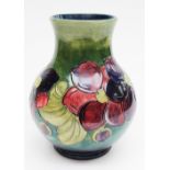 A Moorcroft baluster vase, green ground with tube lined Clematis pattern,