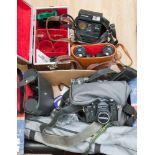 A box of assorted cameras and accessories, including binoculars,