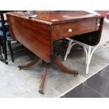 An early 19th century mahogany pedestal Pembroke table,