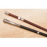 An embossed and cast silver handled and ebonised walking stick with silver collar,
