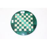 A malachite and marble inlaid chessboard