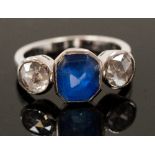 An 18ct white gold three stone ring set with a rose cut blue sapphire and two rose cut diamonds