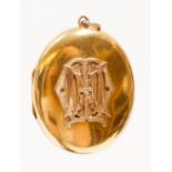 A Victorian oval yellow metal Locket with gold applied monogram to the front