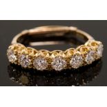 ***REOFFER JULY £300/500*** A seven stone diamond ring set in 18ct yellow gold with each stone