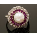 A diamond and ruby cluster ring with a cultured pearl (raised) to the centre, continental,