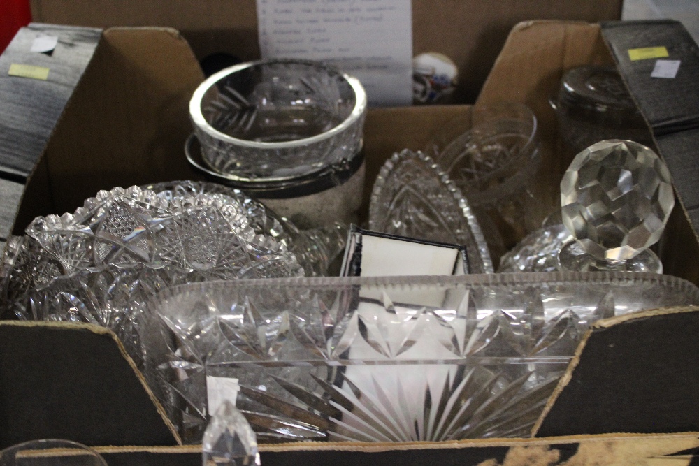 Four boxes of assorted glassware including cut glass, decanters, paperweights, champagne saucers,