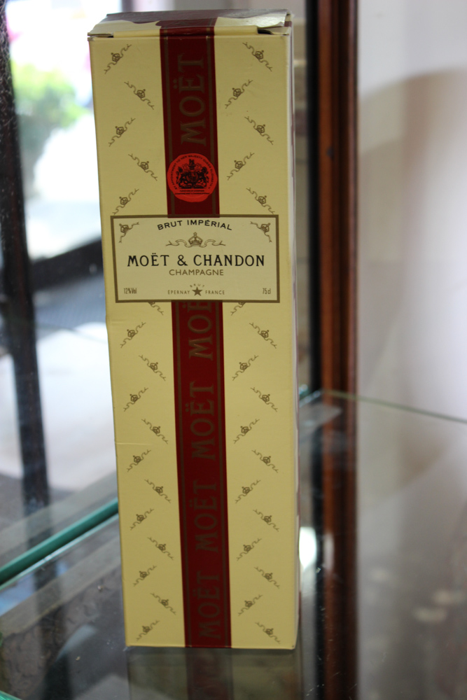 A Moet and Chandon bottle of champagne, complete with box.