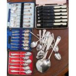A collection of silver plated flatware, comprising tea spoons, knives, dessert forks, etc.