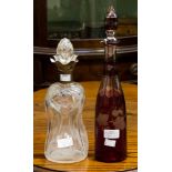 Two glass decanters, one with silver collar,
