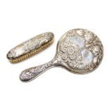 A George V silver backed hand mirror and matching brush, embossed flower and ribbon decoration,