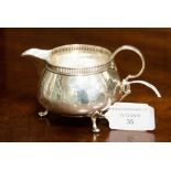 A sterling silver cream jug, rubbed marks,