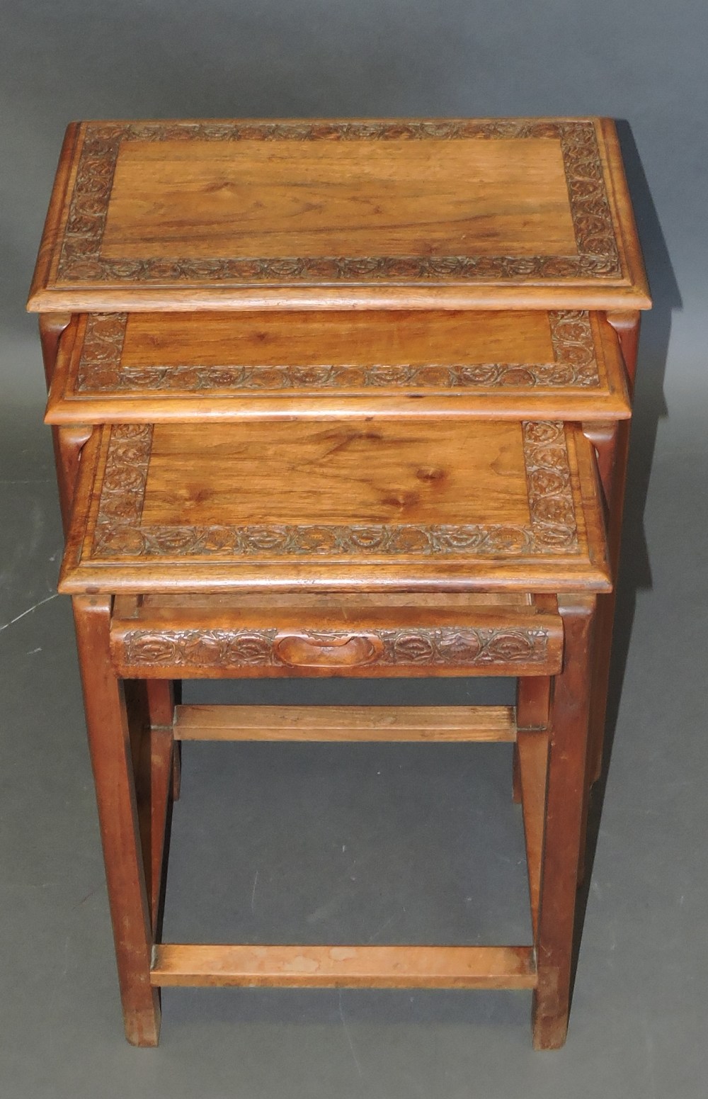 A nest of three oriental hardwood tables