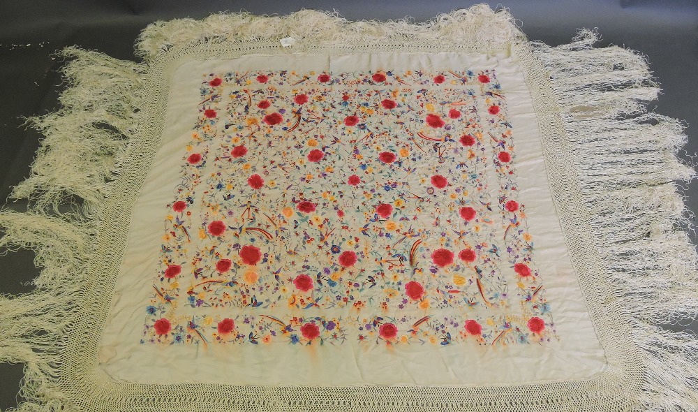 A cream silk piano shawl, embroidered wi