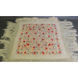 A cream silk piano shawl, embroidered wi