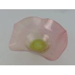 A pink and green vaseline glass bowl wit