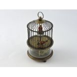 A novelty clock in the form of two caged