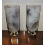 A pair of opaque glass storm lanterns on