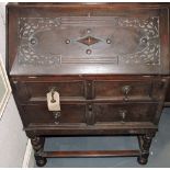 A Jacobean Revival carved oak two-drawer