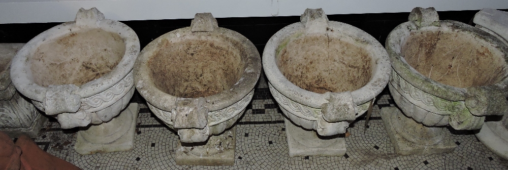 Four cast stone garden urns by Decogarde