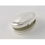 A white metal pill box, oval, stamped 92