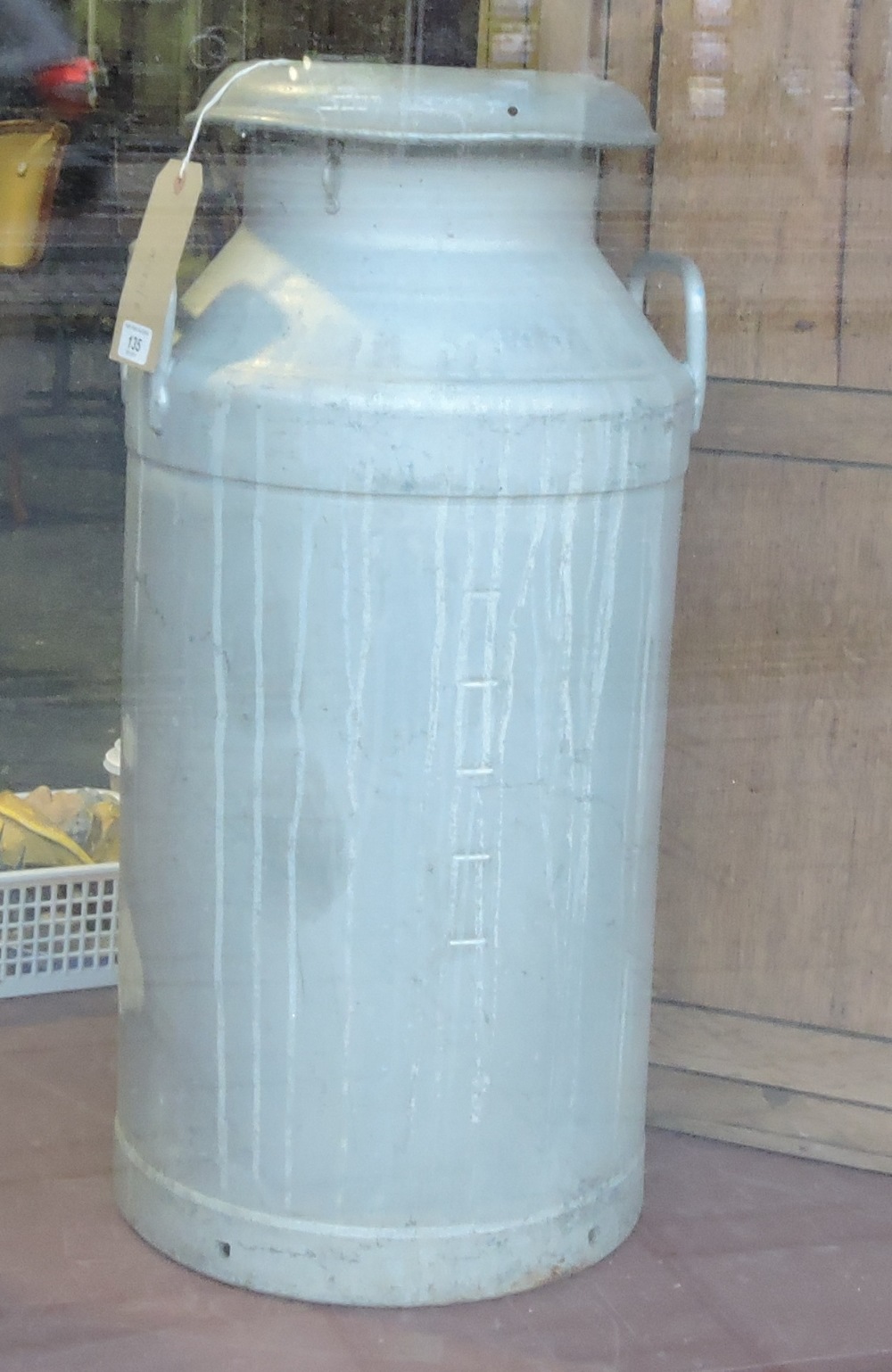 A vintage aluminium milk churn and cover