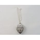 A white metal heart-shaped perfume bottl