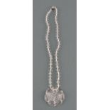 A rock crystal pendant necklace, carved