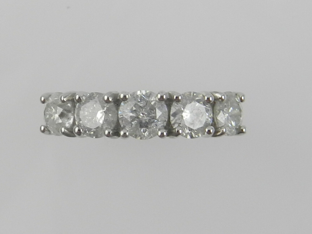 A white metal five stone diamond ring, the stones of approx. 1.81 carats combined, the shank stamped