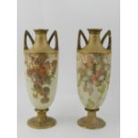 A pair of Royal Doulton twin handled vas