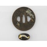 A Japanese bronze tsuba, engraved and mo