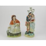 A pair of late 19th / early 20th century Staffordshire figurines, one depicting Scottish couple, the