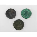 A collection of three Roman coins, comme