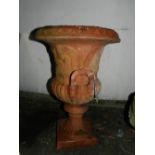 A terracotta plant pot in the style of a