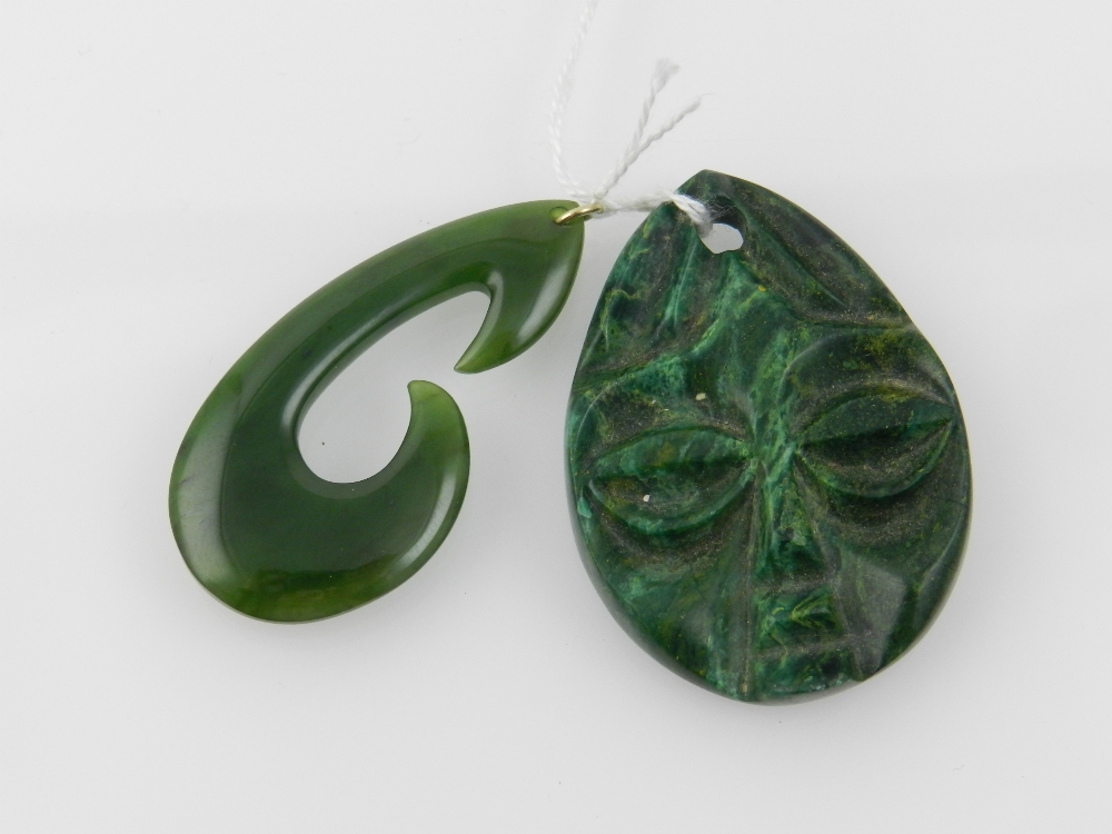 A malachite pendant carved with a face t