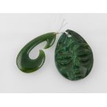 A malachite pendant carved with a face t