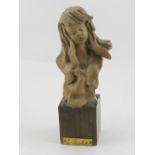 An earthenware bust of a young lady, mounted upon a square wooden base, signed to verso 'L.
