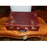 Three brown leather briefcases, having gilt metal locks and pen and document compartments,