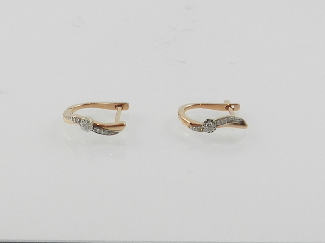 A pair of 14 carat rose gold and diamond hoop earrings.