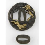 A Japanese tsuba, having moulded decorat