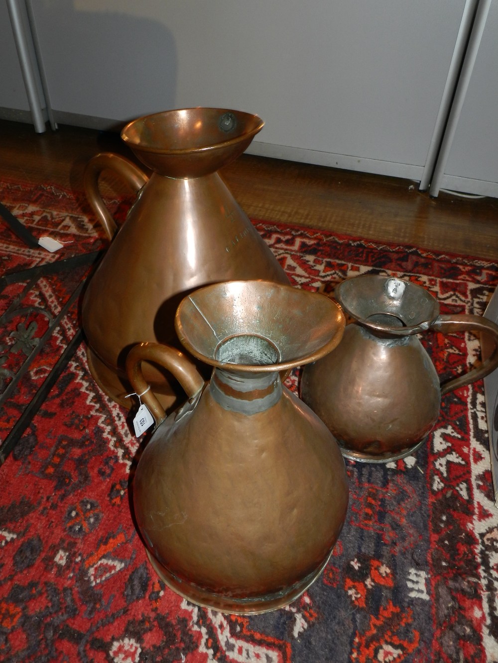 A set of three copper jugs, engraved '4