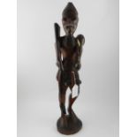 An African carved wooden figure, standin