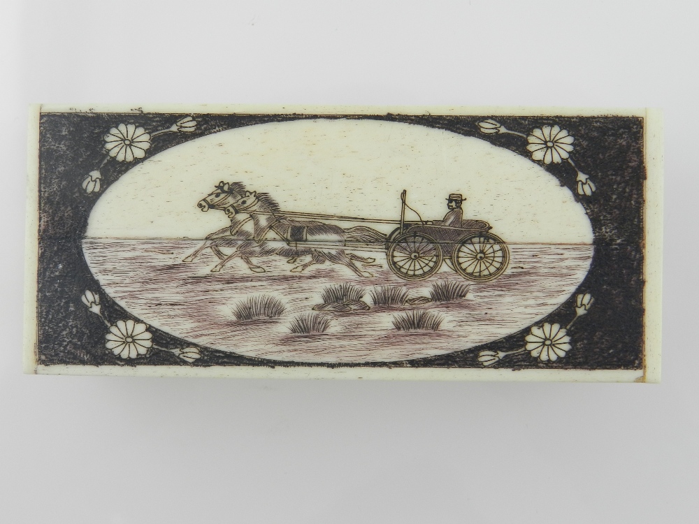 A scrimshaw style bone trinket box, the