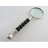 A table magnifier with turned handle and