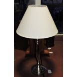 A nickel plated table lamp with cream sh