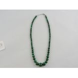 A malachite necklace of graduated beads,