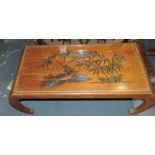 An Oriental hardwood coffee table, the r