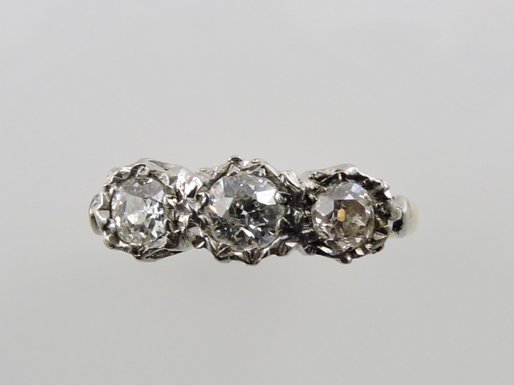 A three stone diamond dress ring, in ill