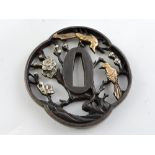 A Japanese pierced bronze tsuba, decorat