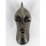 A tribal mask of Zaire, with raised comb